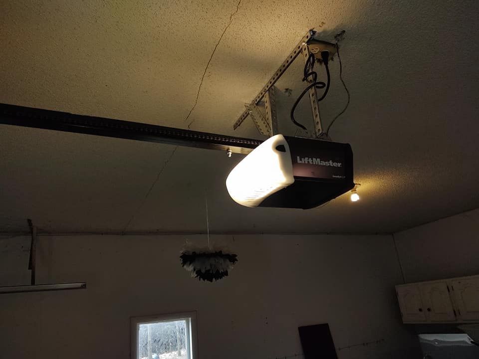 A liftmaster garage door opener is hanging from the ceiling