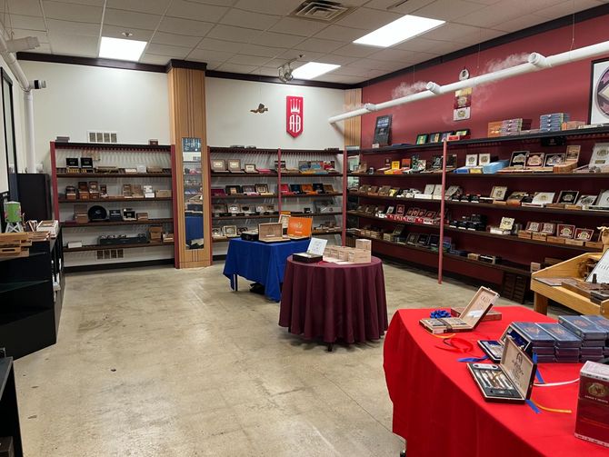 A large room with tables and shelves filled with cigars.