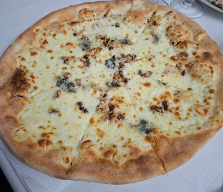 Pizza al formaggio con bollicine dorate su un piatto bianco