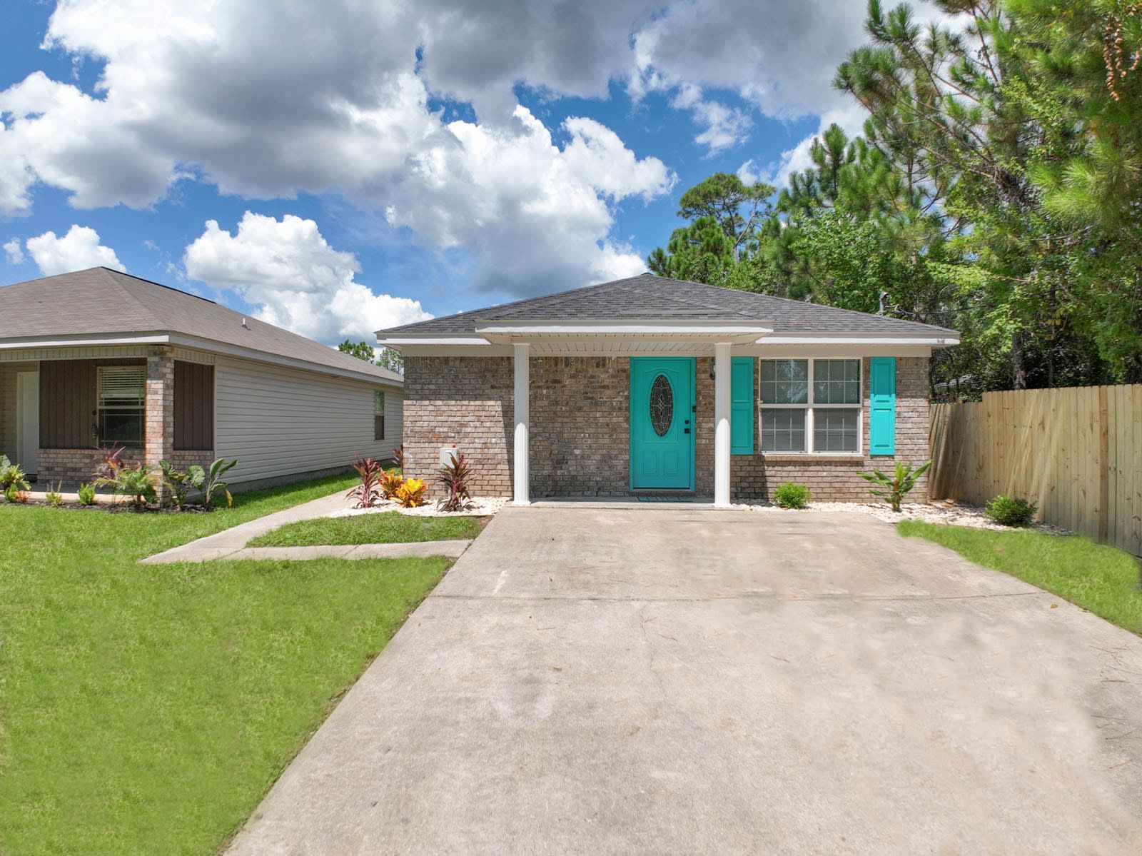 A brick house with a blue door and blue shutters