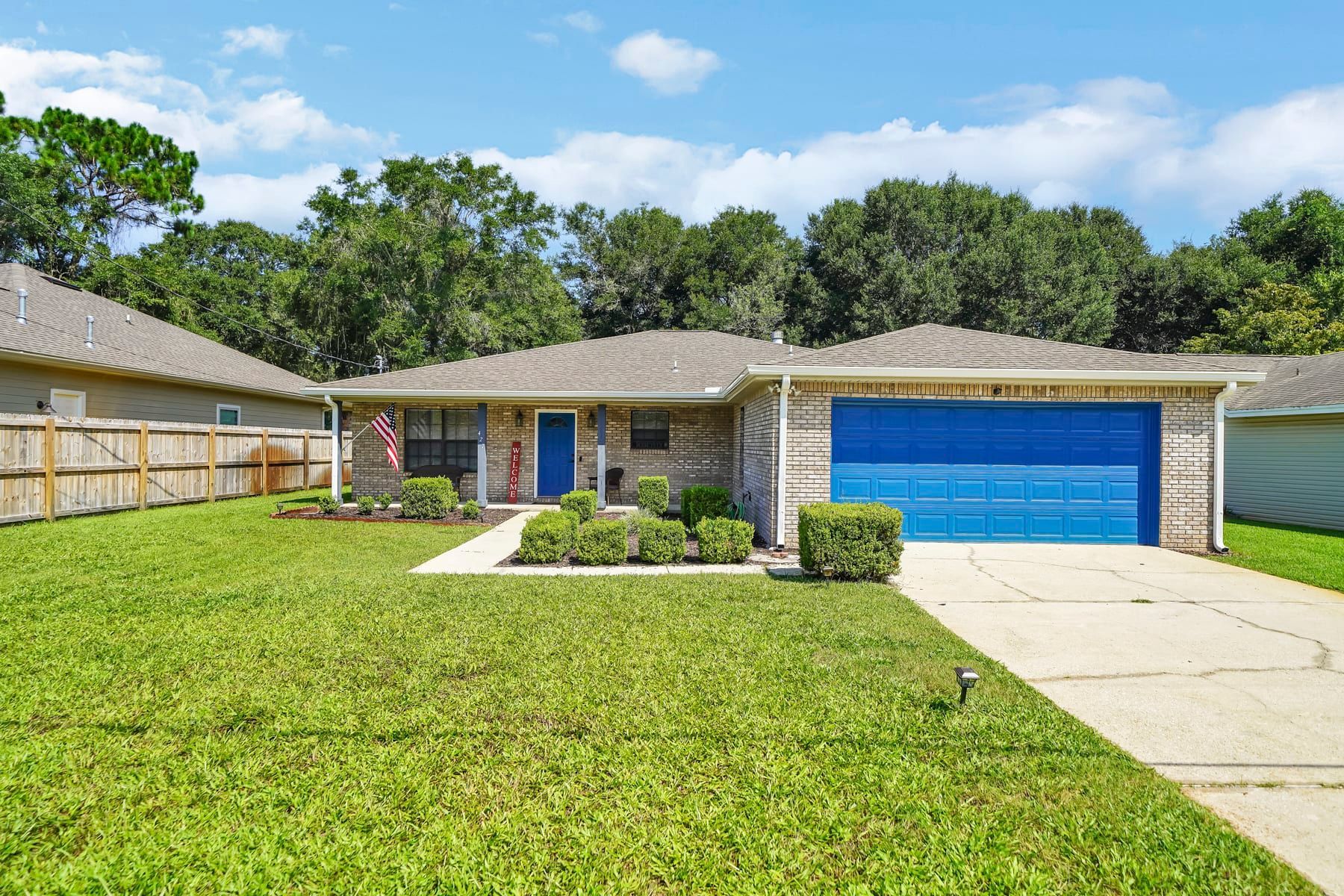 A house with a blue garage door is for sale.