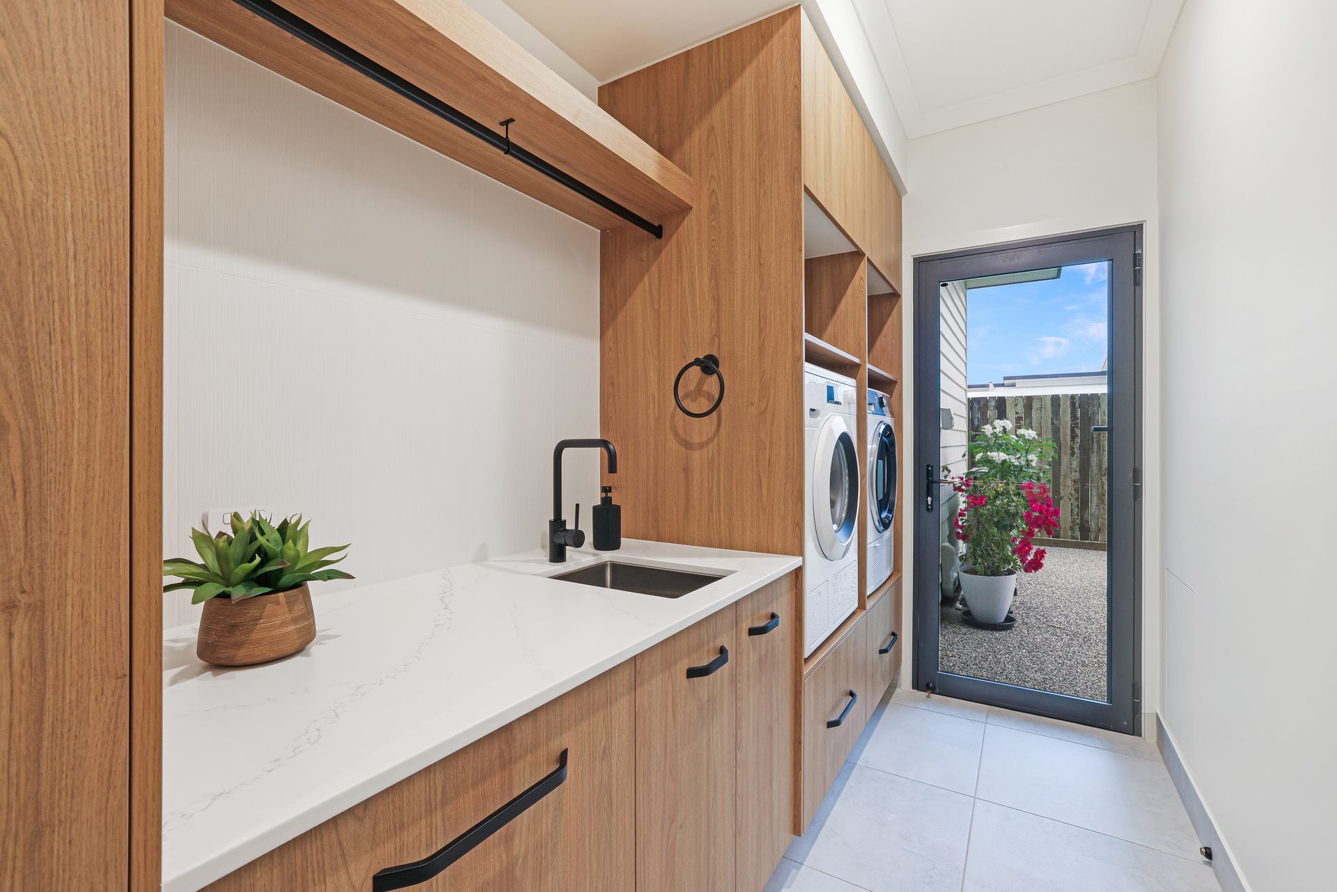 A Kitchen With Gray Cabinets, A Sink, And A Refrigerator — Master Cabinets Bundaberg in Kensington, QLD