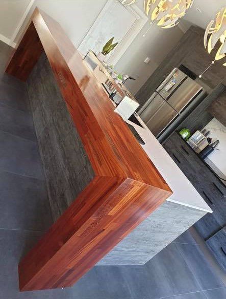 A Kitchen With A Wooden Counter Top And A Refrigerator — Master Cabinets Bundaberg in Gin Gin, QLD