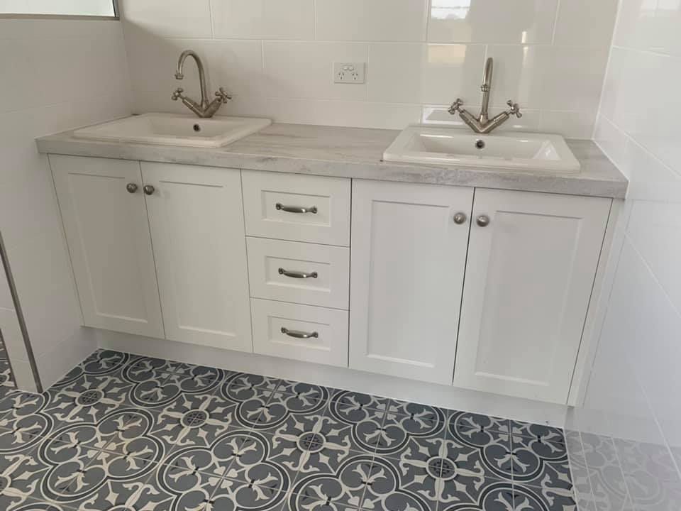 A Bathroom With Two Sinks And A Tiled Floor — Master Cabinets Bundaberg in Burrum Heads, QLD