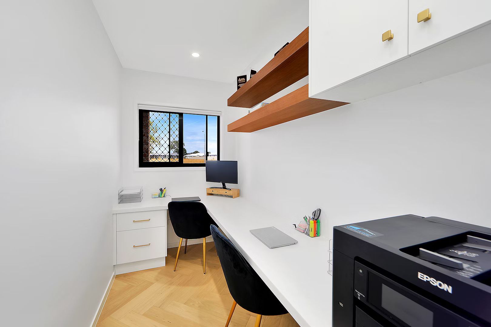 A Desk With A Computer On It In An Office — Master Cabinets Bundaberg in Gin Gin, QLD