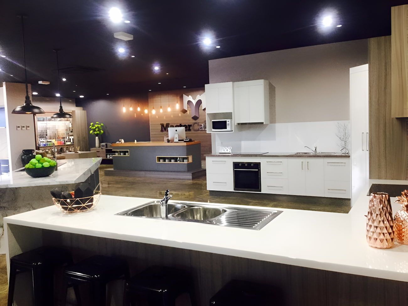Kitchen Showroom With White Cabinets, Stainless Steel Sink — Master Cabinets Bundaberg in Bargara, QLD