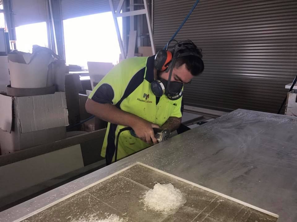 Worker Using a Power Tool in a Cabinetry Shop — Master Cabinets Bundaberg in Kensington, QLD