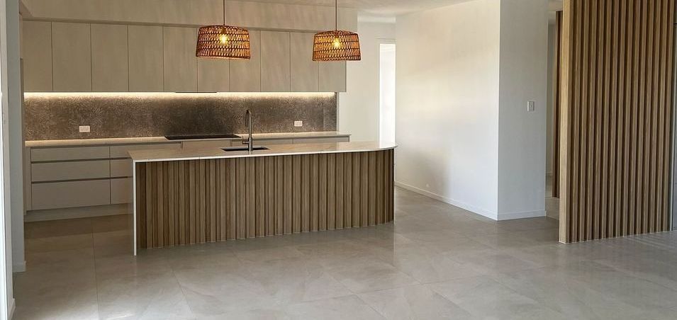 Modern Kitchen With A Wooden Island, Cabinets  — Master Cabinets Bundaberg in Redridge, QLD