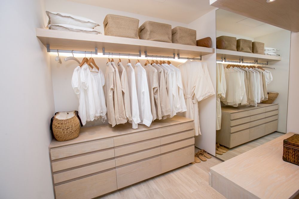 Walk-in Closet With Neutral-toned Clothes, Shelves, And Drawers — Master Cabinets Bundaberg in Kensington, QLD