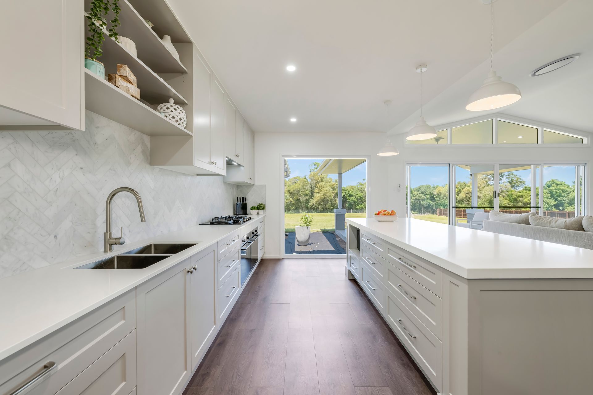 A White House With A Large Swimming Pool In Front Of It — Master Cabinets Bundaberg in Kensington, QLD