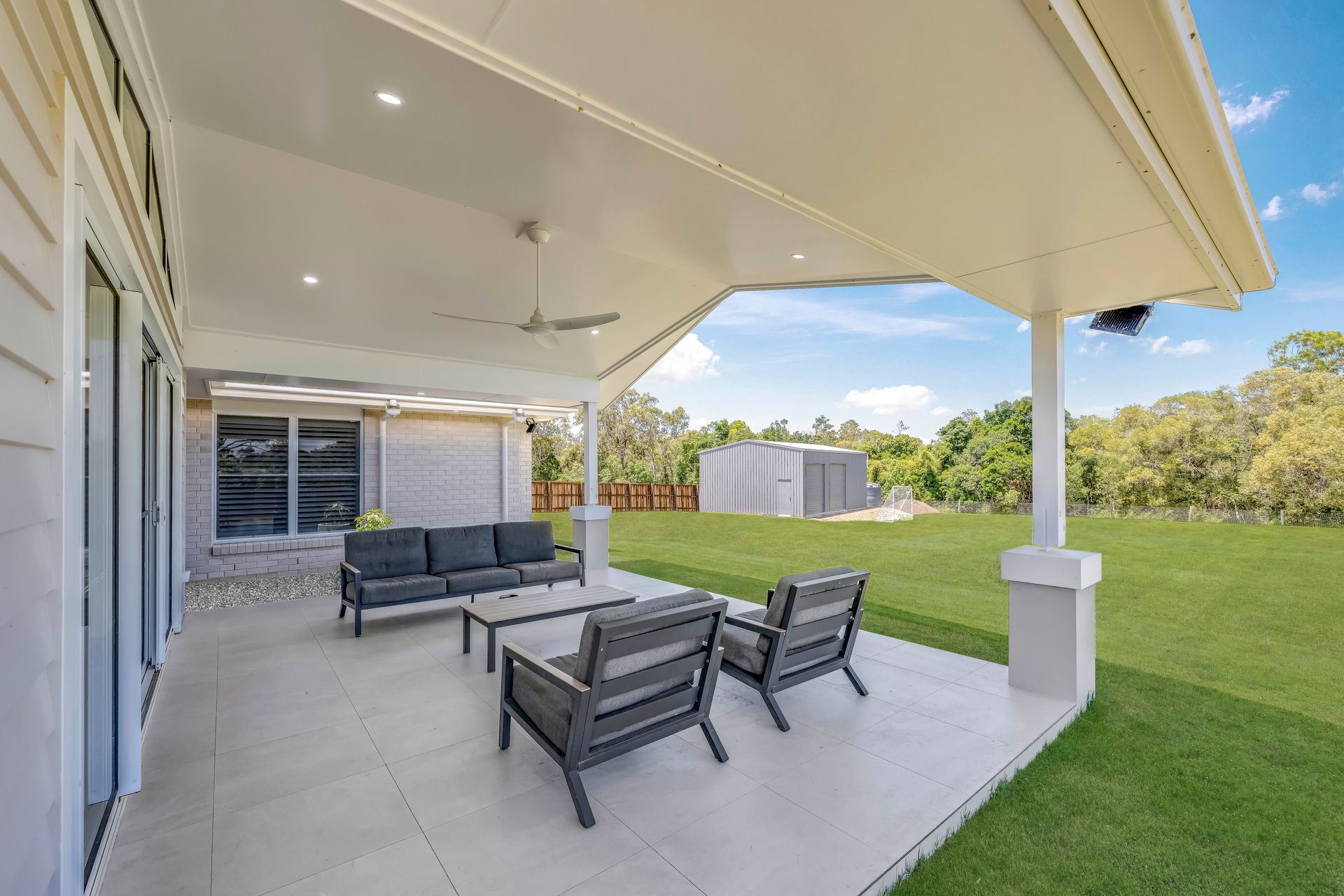 Covered Patio With Seating Overlooking a Grassy Yard — Master Cabinets Bundaberg in Kensington, QLD