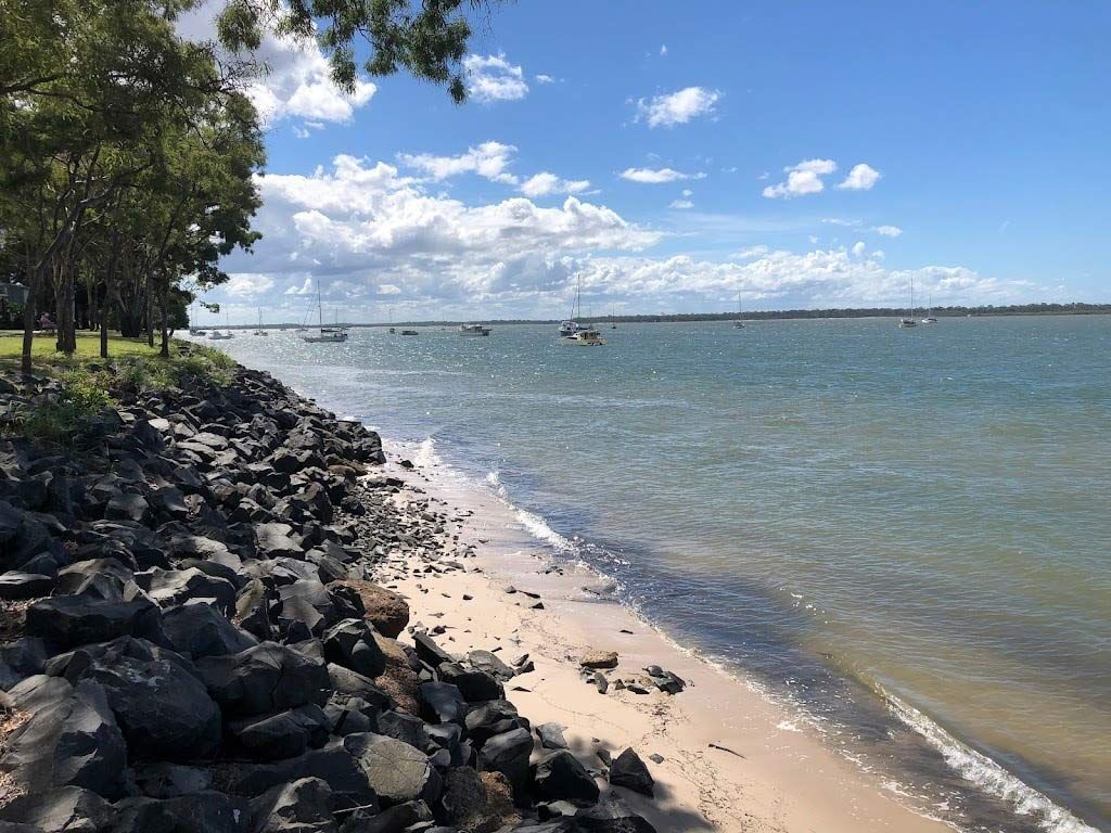A Beach With A Lot Of Rocks And Boats In The Water — Master Cabinets Bundaberg in Burrum Heads, QLD