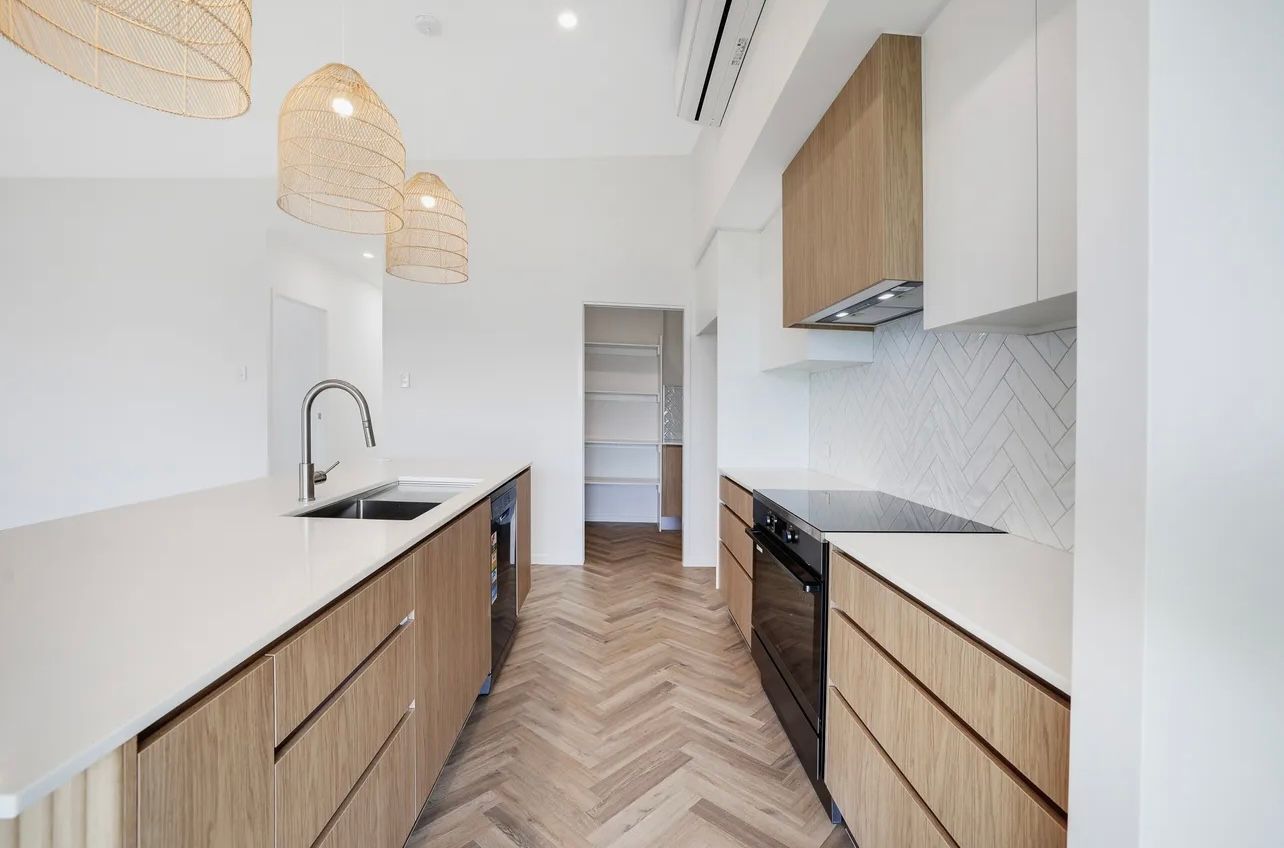 Modern White Kitchen With Floating Shelves — Master Cabinets Bundaberg in Kensington, QLD