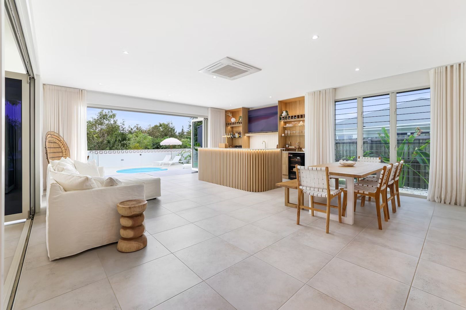 A Wooden Wardrobe With Sliding Doors In A Hallway With White Doors — Master Cabinets Bundaberg in Burrum Heads, QLD