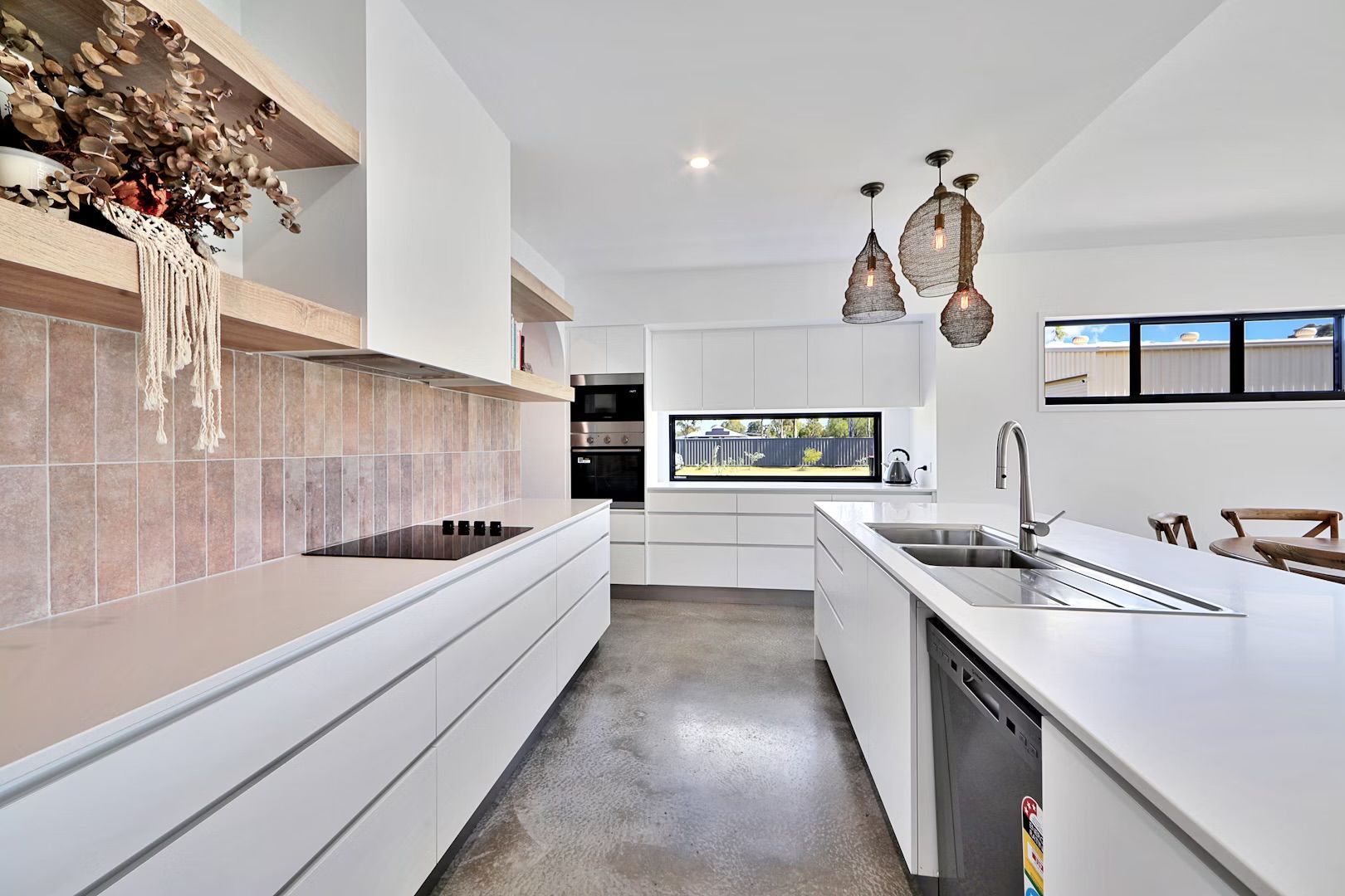 A Kitchen With A Sink And A Table That Can Be Pulled Out — Master Cabinets Bundaberg in Agnes Water, QLD