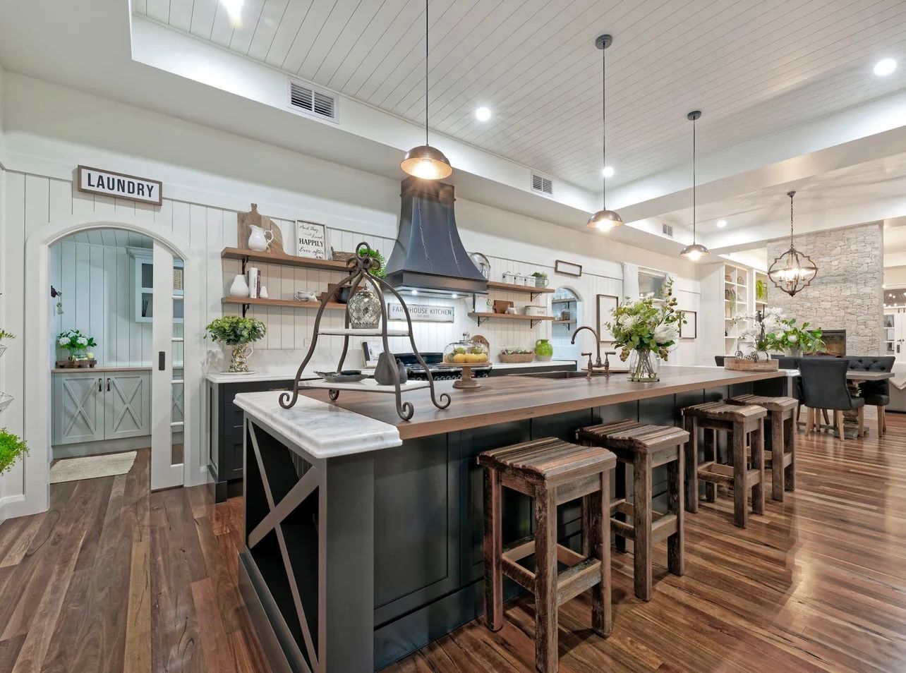 Office Space With Black Desks, Bookshelves, And Potted Plants — Master Cabinets Bundaberg in Kensington, QLD