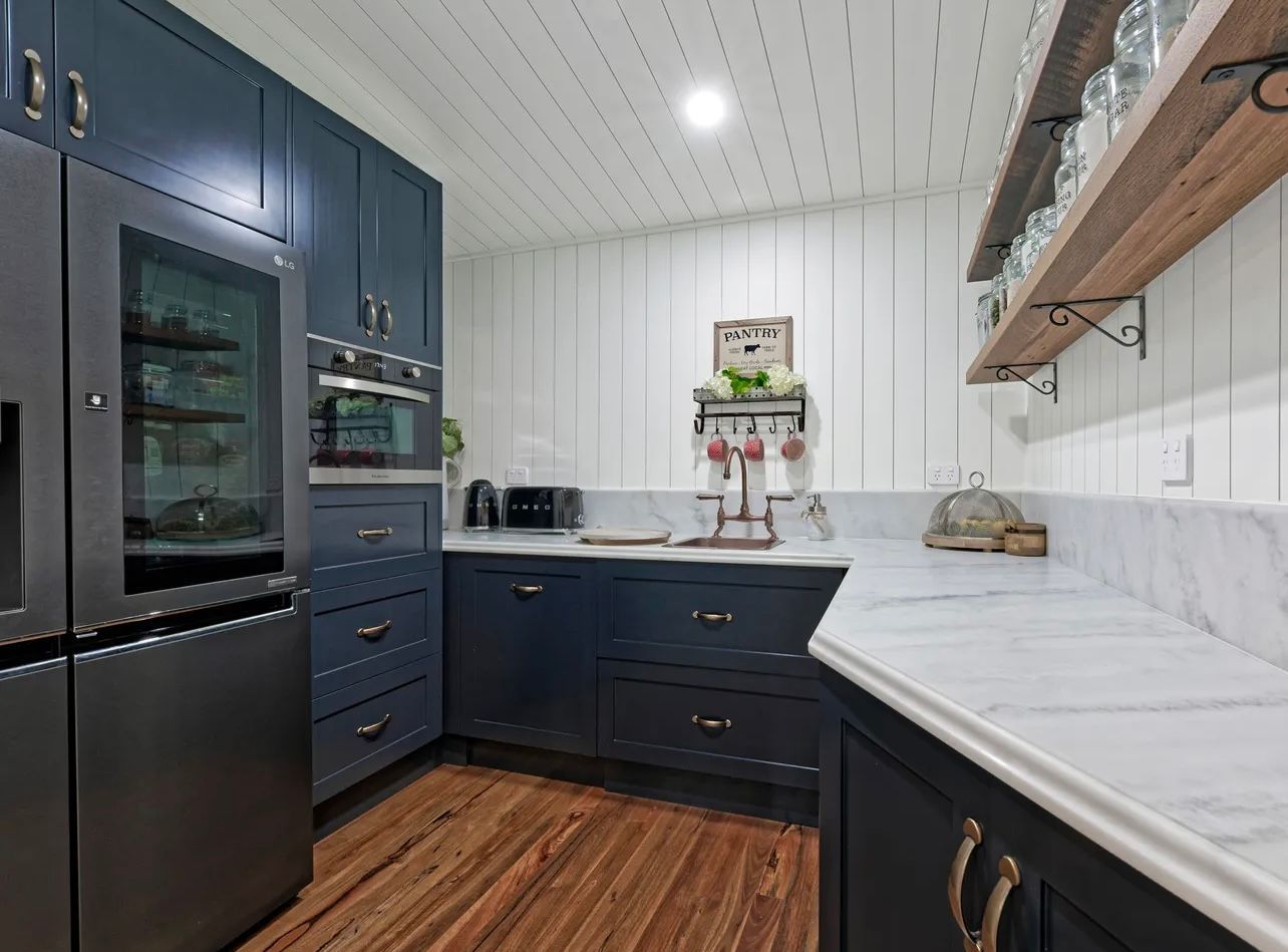 A Bathroom With Two Sinks And A Tiled Floor — Master Cabinets Bundaberg in Burrum Heads, QLD