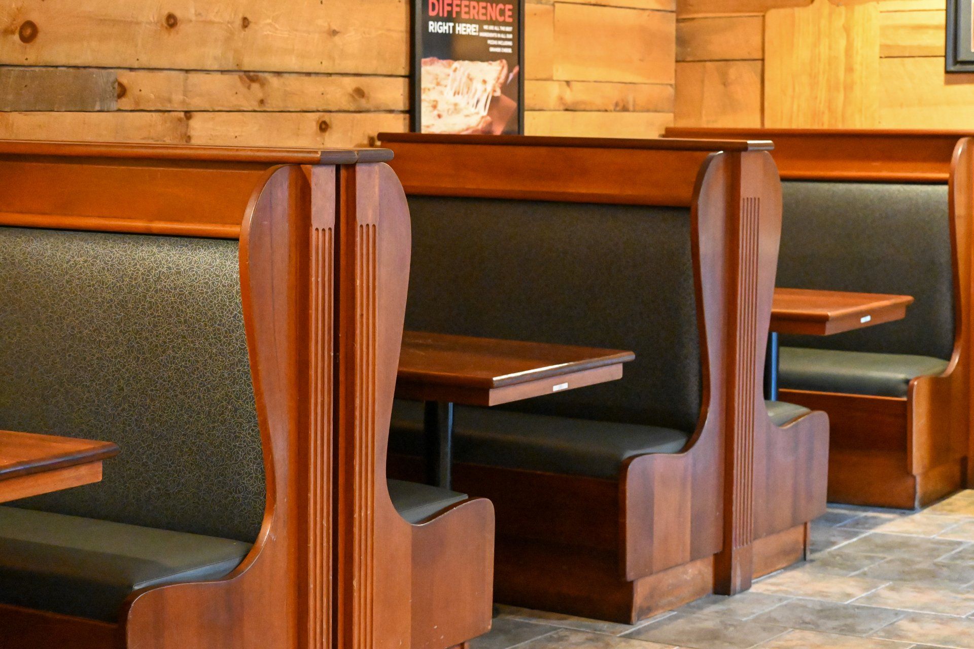 A row of booths in a restaurant with a sign that says difference