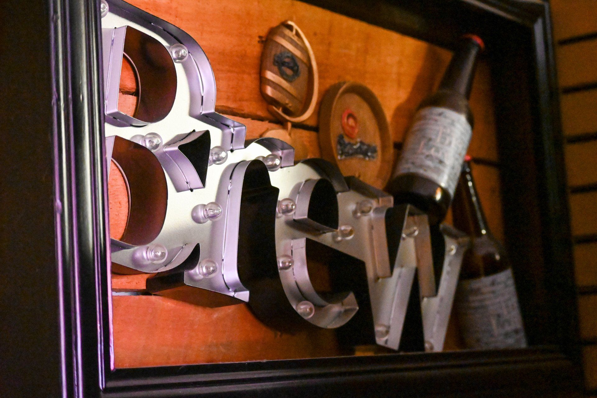 A framed sign that says brew on it