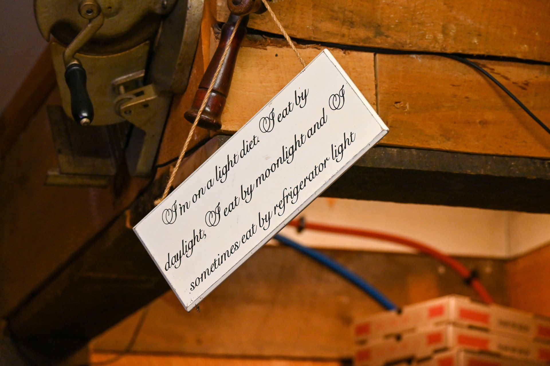 A sign hanging from the ceiling that says knowledge is the key