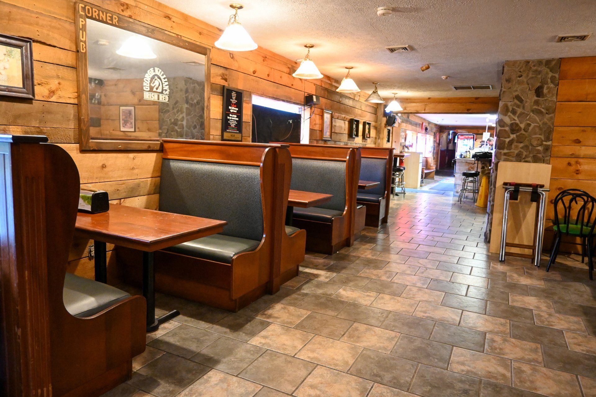 A restaurant with a lot of booths and tables
