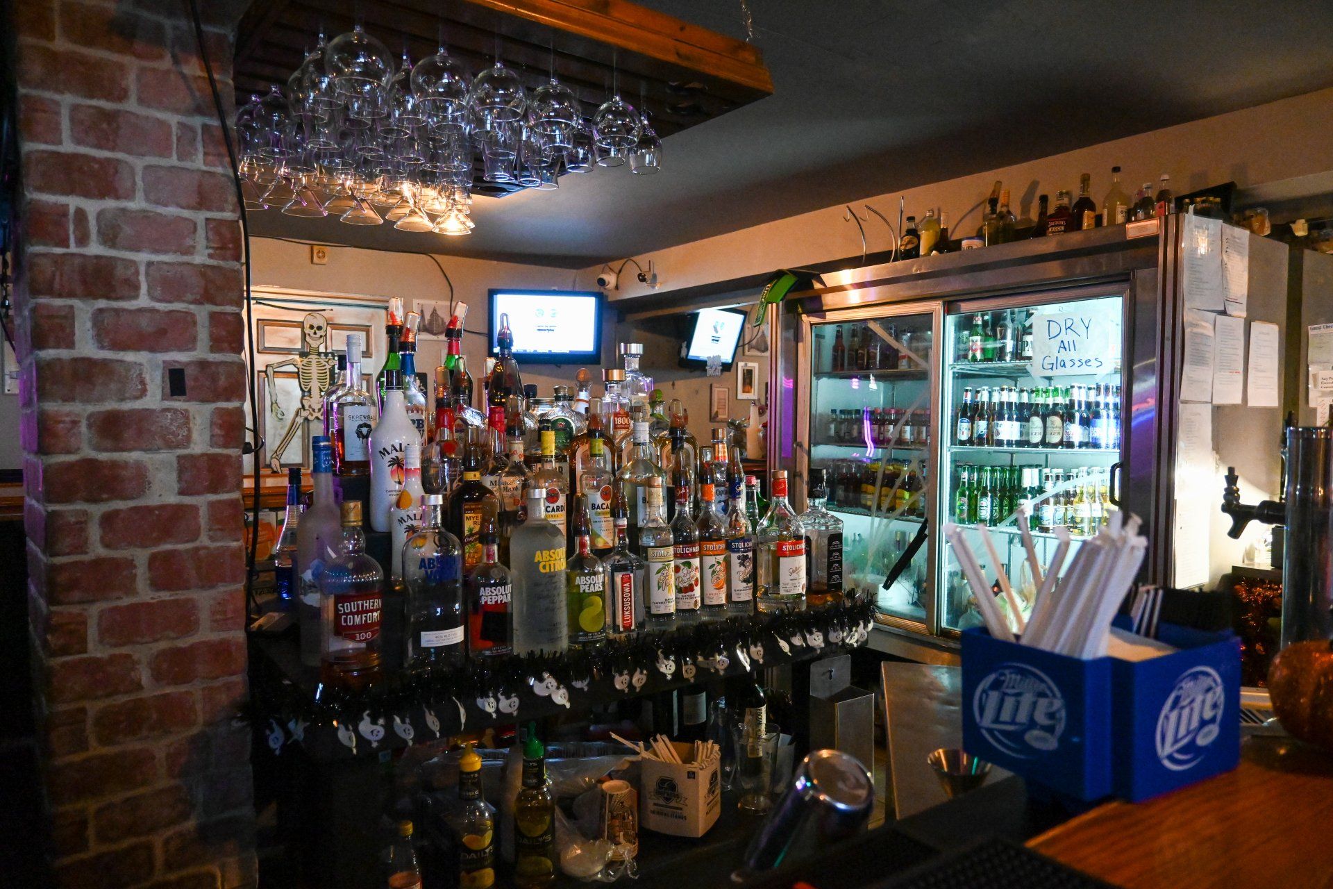A bar with a miller lite box on the counter.
