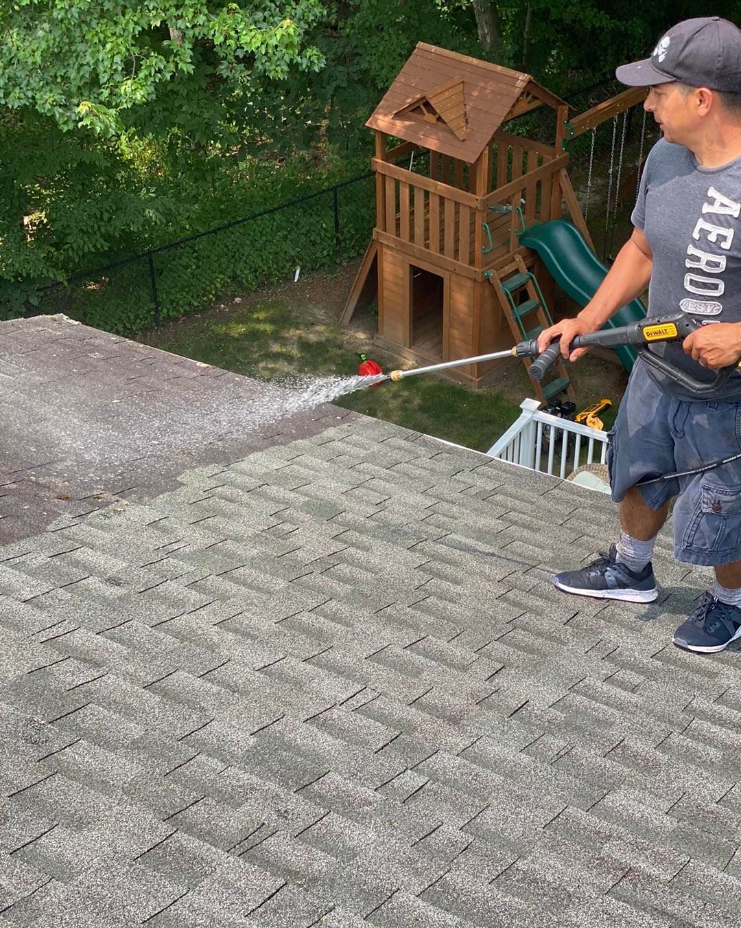 A roof with a lot of shingles and trees in the background.