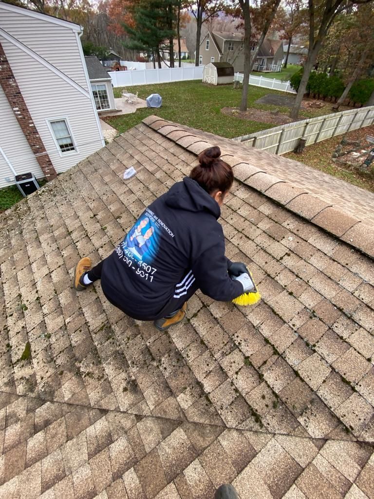 A roof with a lot of shingles and trees in the background.