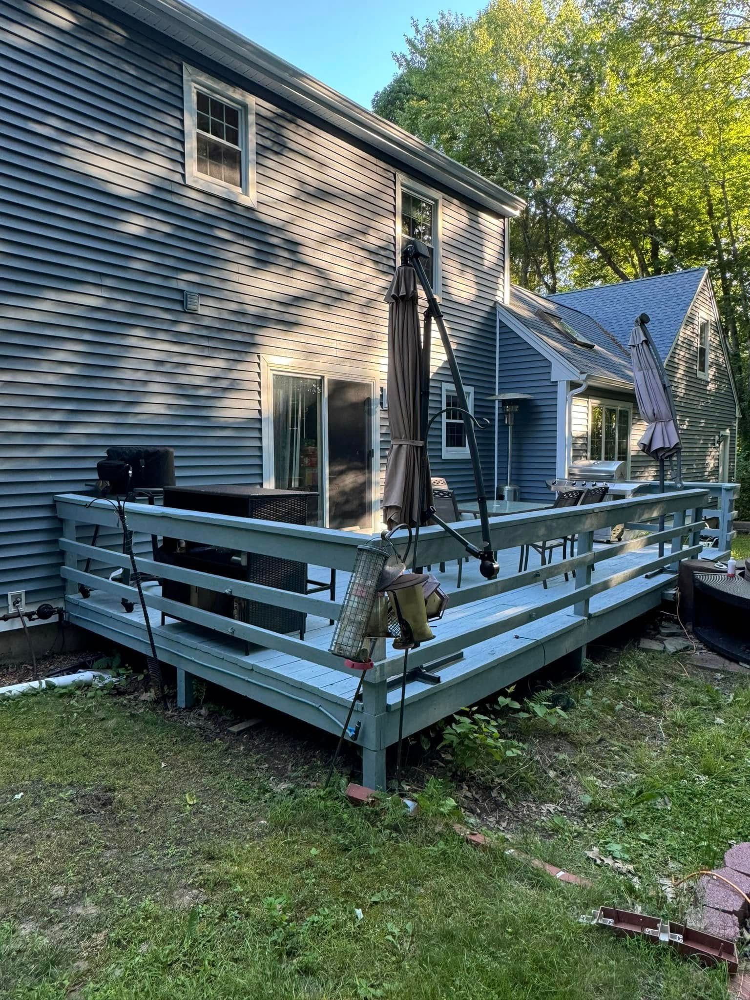 A wooden deck with a table and chairs on it.