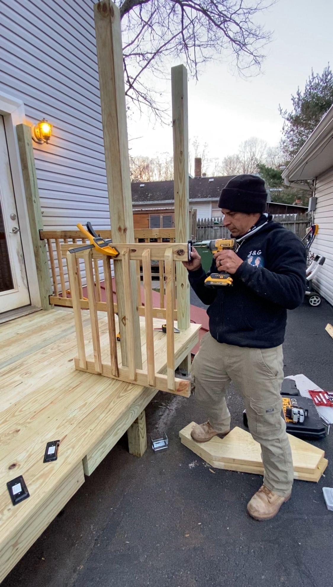 A wooden deck with a table and chairs on it.