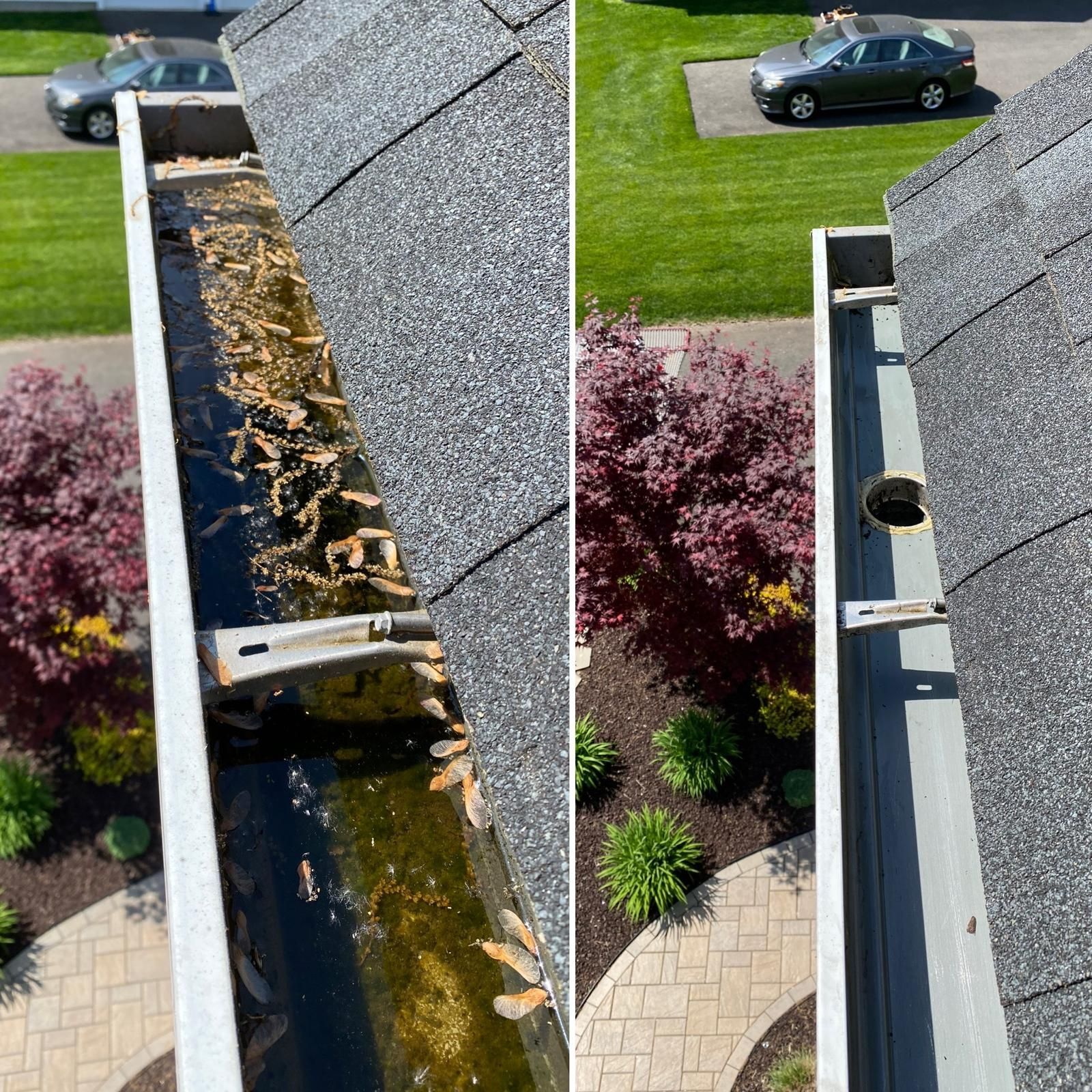 A gutter is sitting on top of a roof next to a deck.