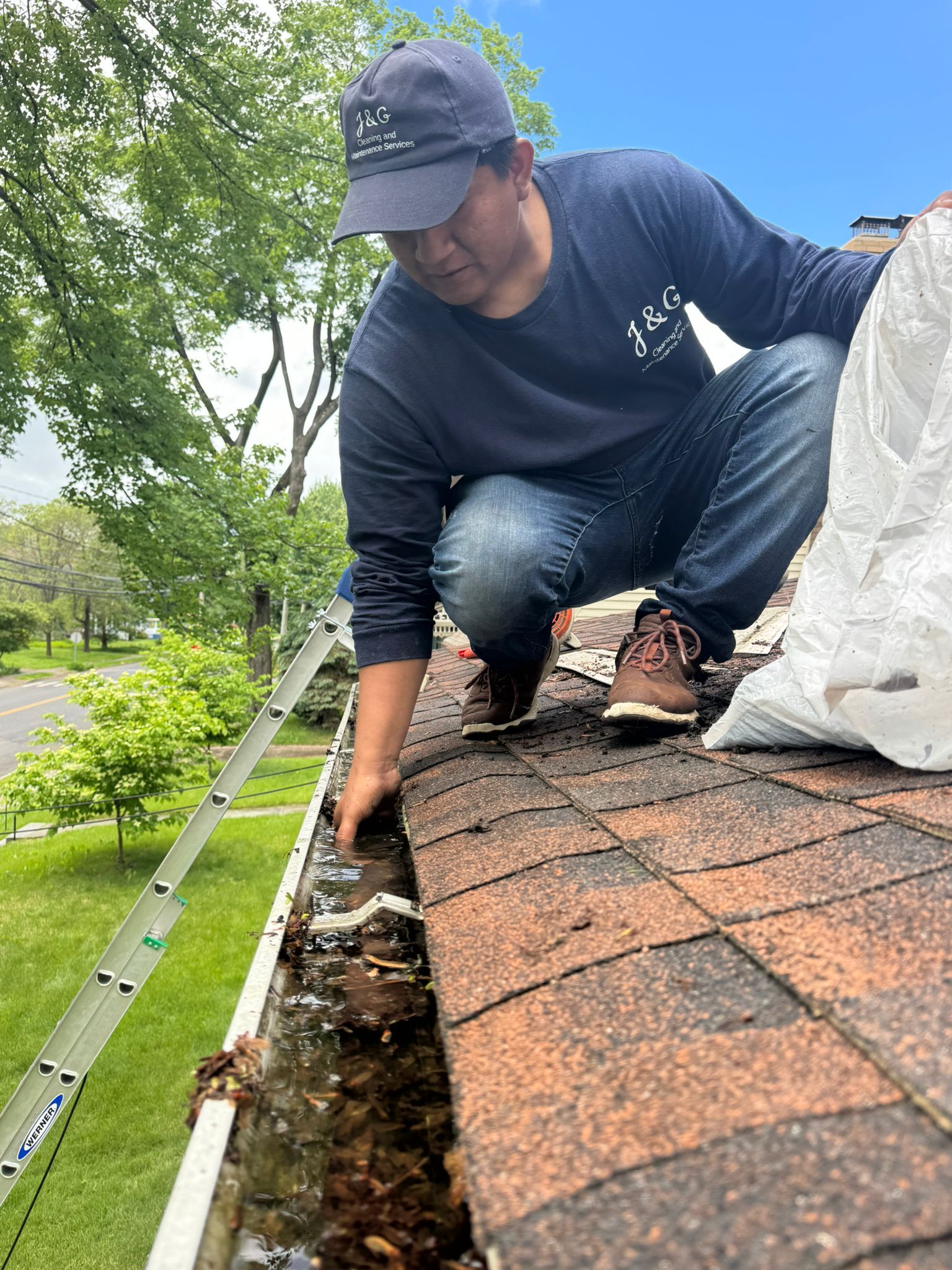 A gutter is sitting on top of a roof next to a deck.