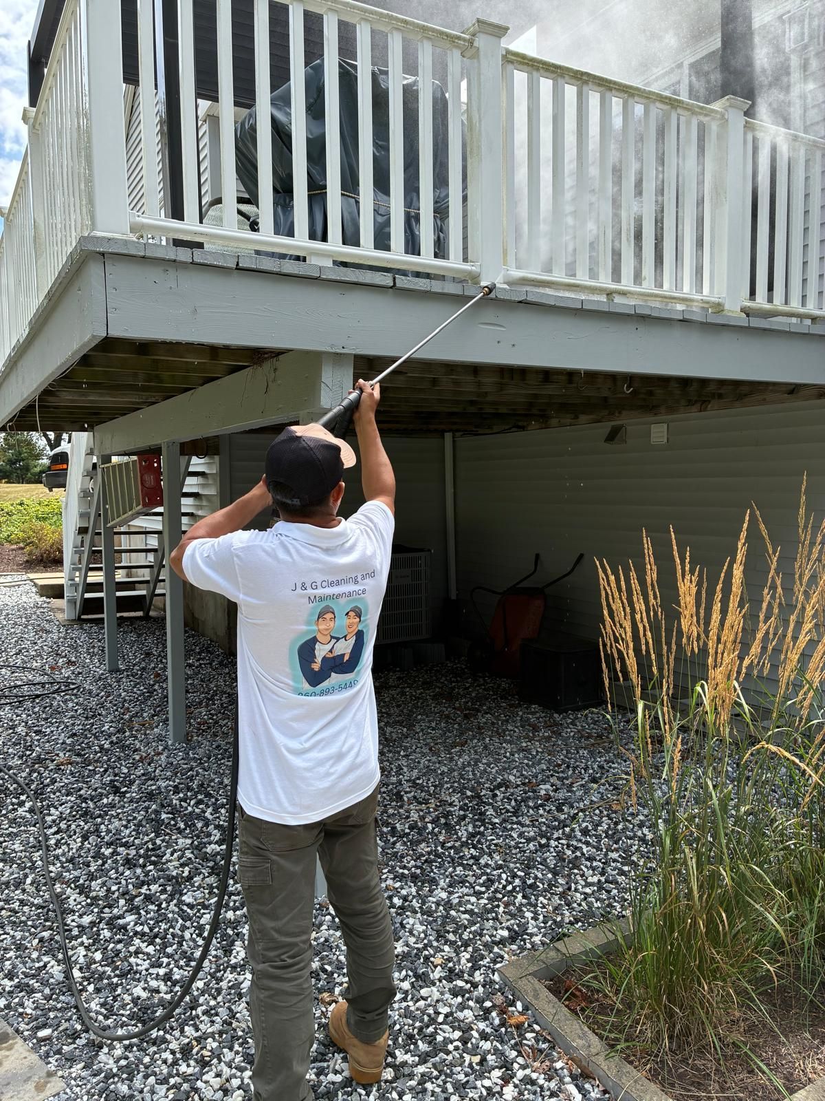 Deck Power Washing New Britain CT Technician power washing wooden deck in New Britain CT by J & G Cleaning