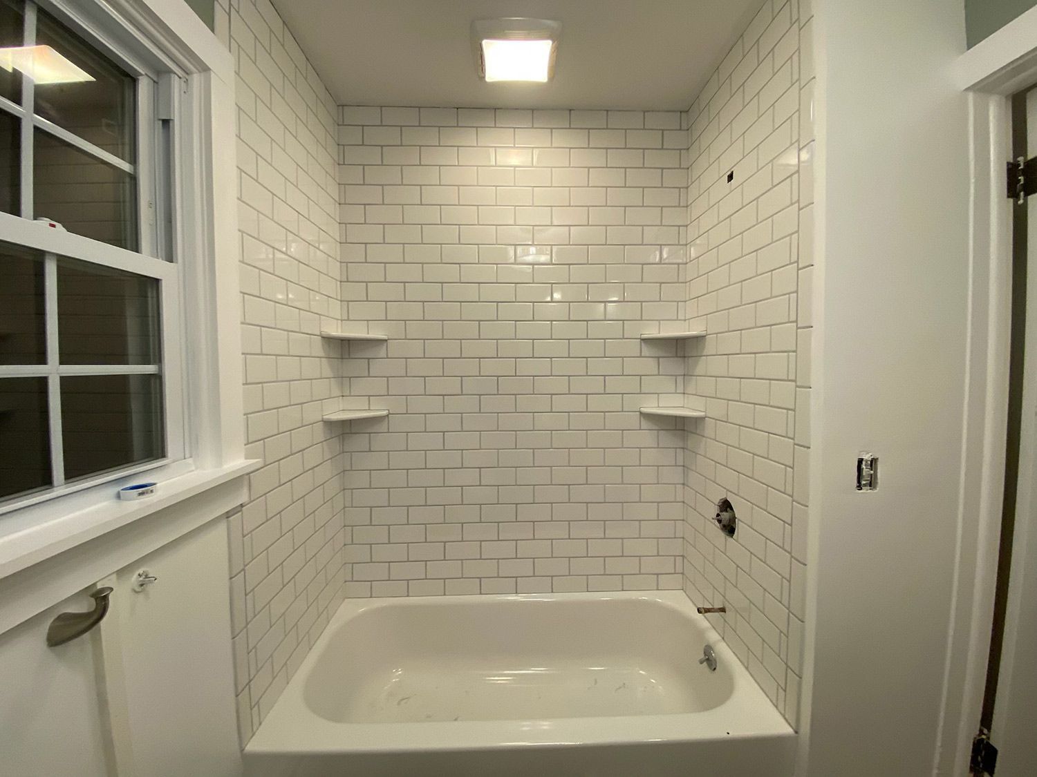 Bathroom with Bathtub and Brick Walls