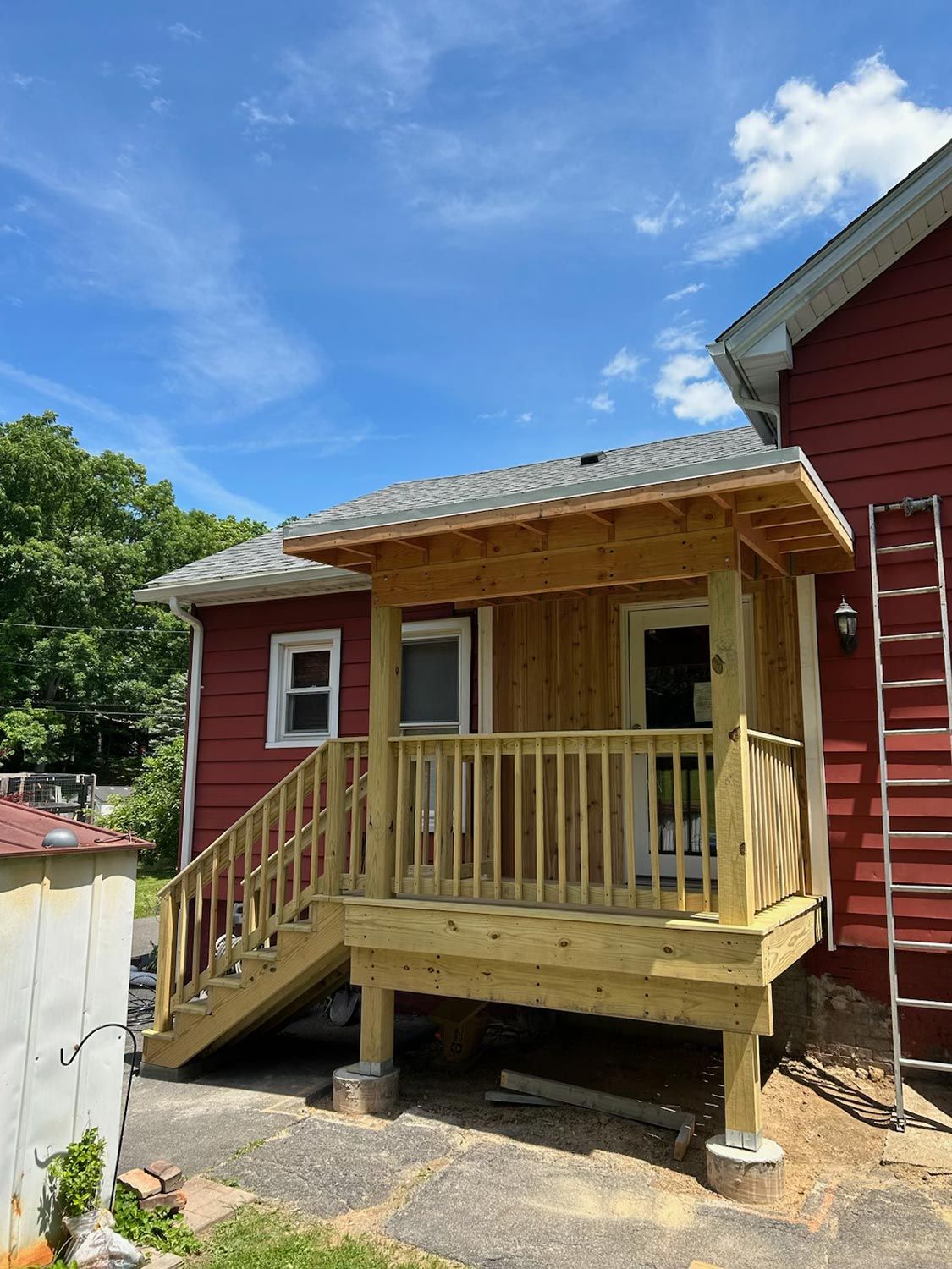 Wooden Deck on the Side of a Red House