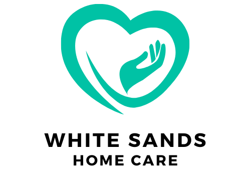 The logo for white sands home care shows a heart with two hands inside of it.