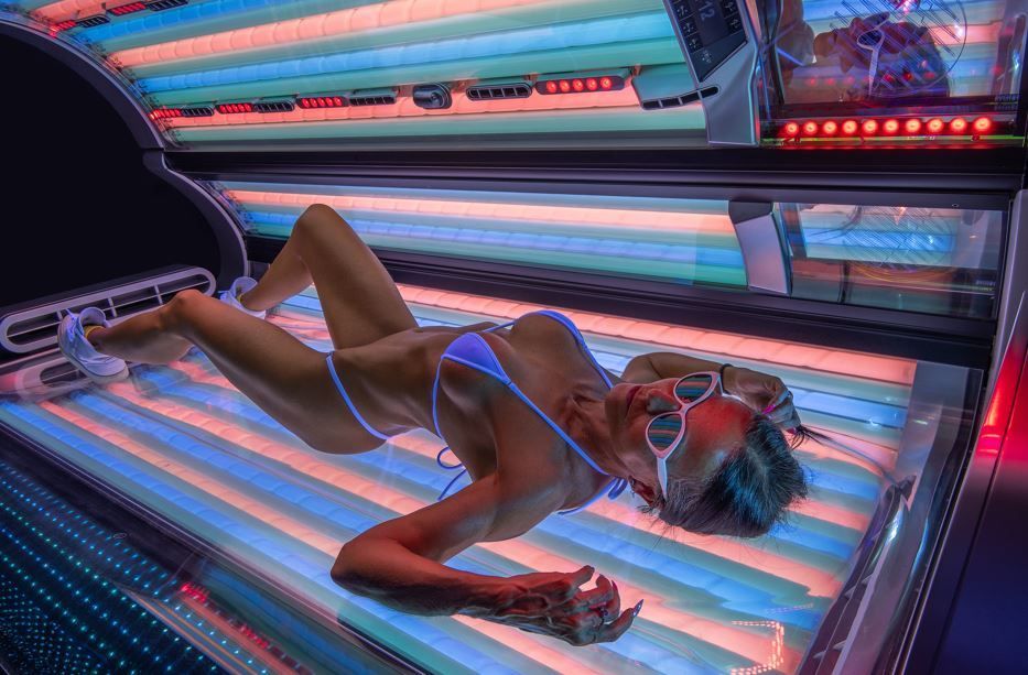 An attractive woman lies in a solarium at Sunworld tanning studio in Zurich