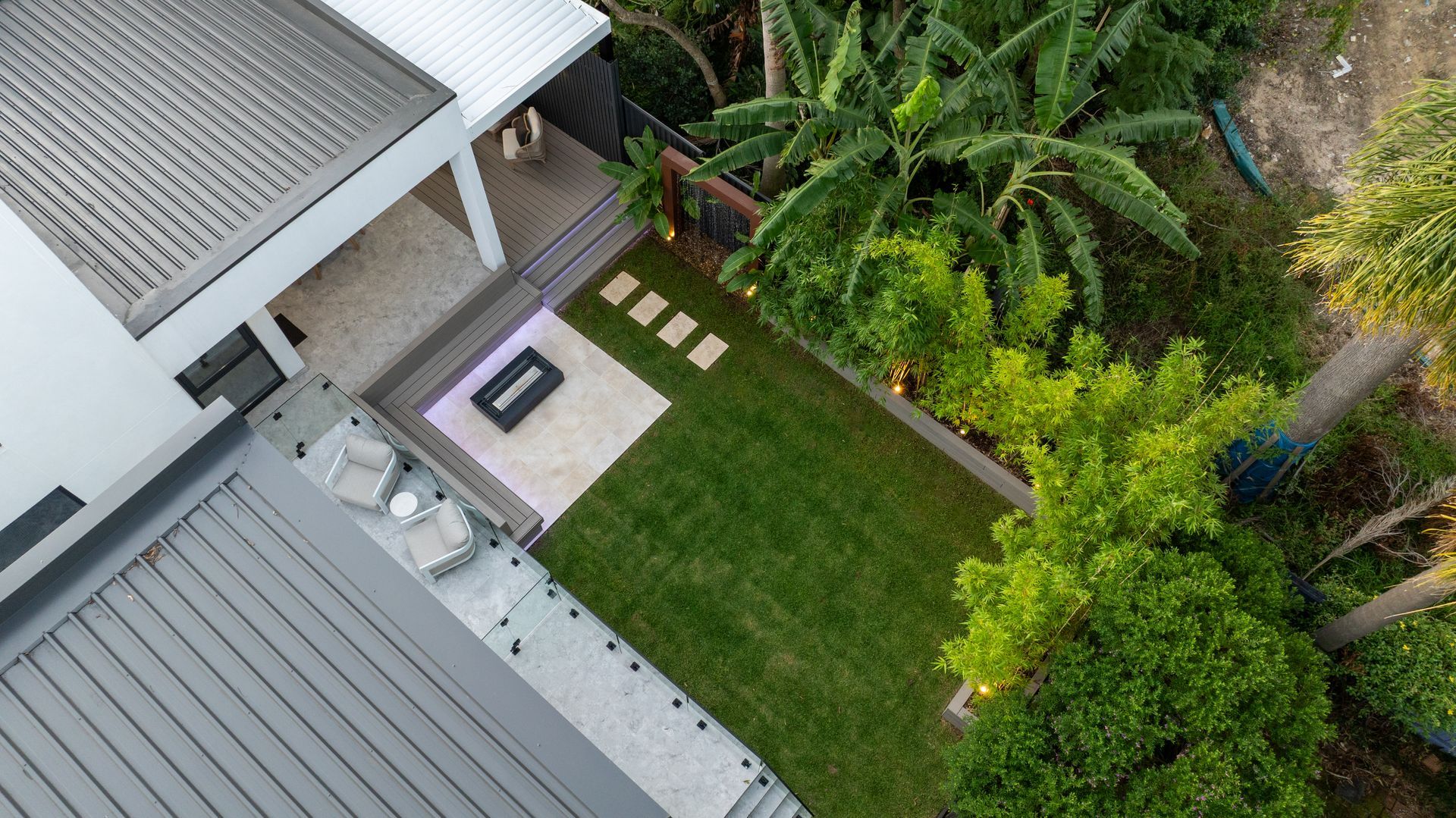 An aerial view of a house and a lush green yard.