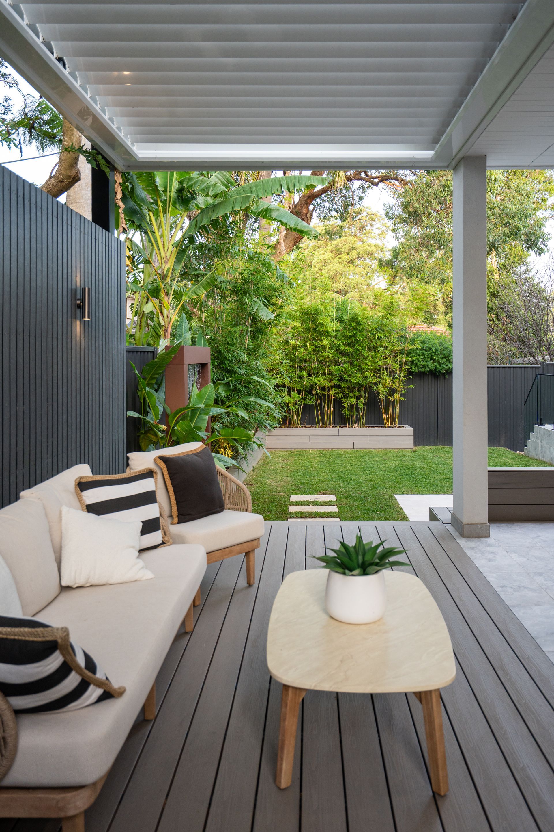 There is a couch and a table on the deck.