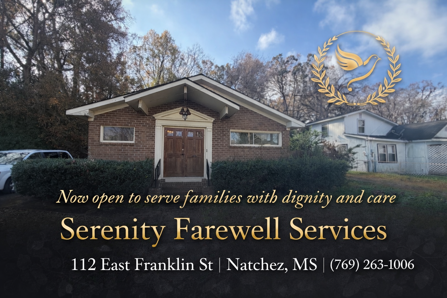 A large white building with a brown roof and a lot of windows.