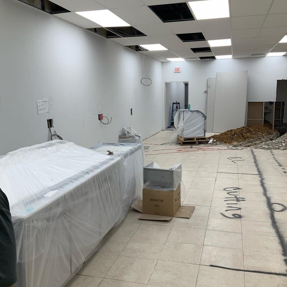 An empty room with a box on the floor that says lifting