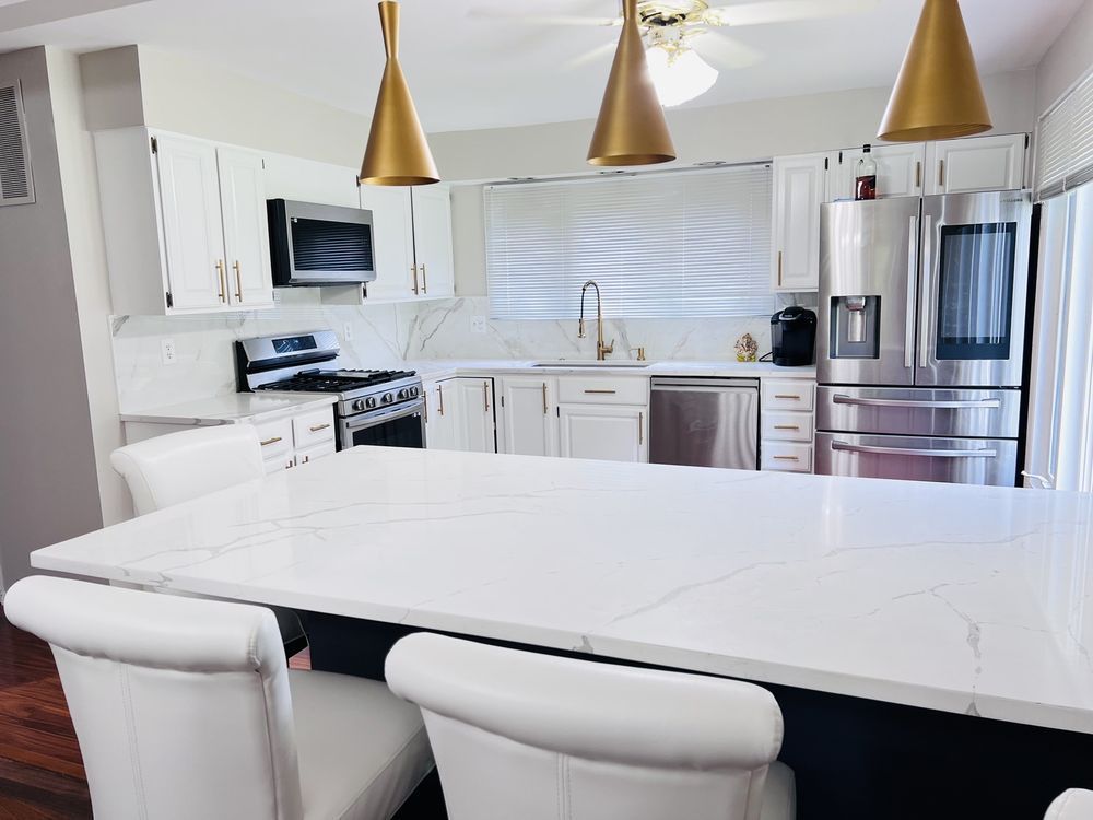 A kitchen with white cabinets and stainless steel appliances