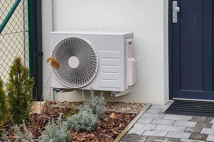 Modern house with heat pump, efficient heating with green energy concept 
