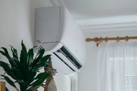 Split air conditioner on a white wall closeup 
