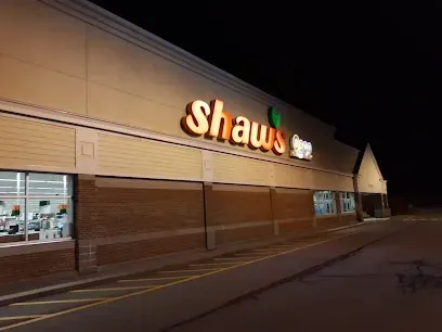 Shaw’s grocery store exterior at night with illuminated storefront sign