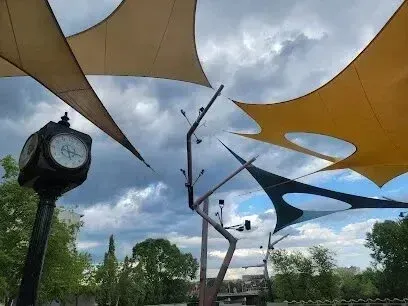 Chimney-Sweep-Portland-A clock tower with a clock on it is surrounded by umbrellas.
