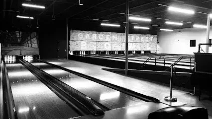 Chimney-Sweep-Portland-Black and white image of a bowling alley with multiple lanes and pinsetters visible.