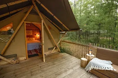 Canvas glamping tent with wooden deck at Huttopia Southern Maine