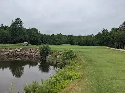 Chimney-Sweep-Portland
Golf course fairway with a water hazard on the left and trees lining the background under a cloudy sky.