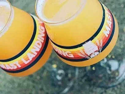 Chimney-Sweep-Portland
-Two glasses of beer with a label that says ' mast landing ' on it